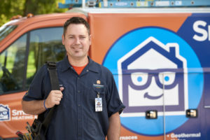 SmartHouse tech smiling with workbag in front of company truck