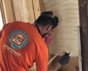 SmartHouse Worker Applying SprayFoam Insulation