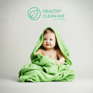 Baby wrapped in green blanket with "Healthy Clean Air" logo