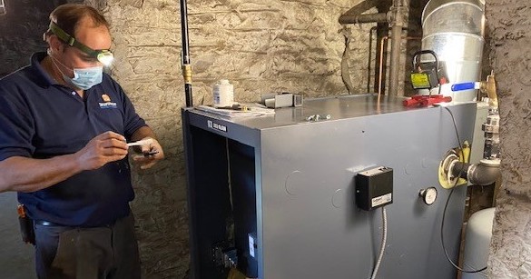 SmartHouse technician installing boiler in basement